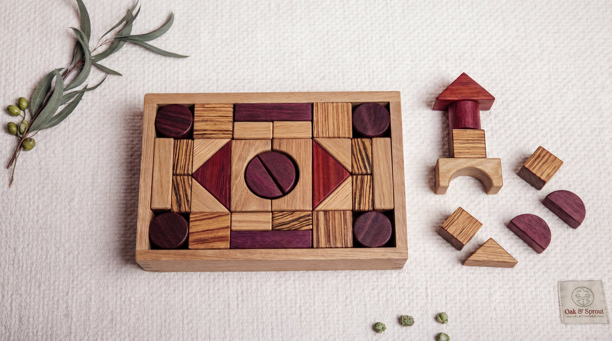 Wooden puzzle and building blocks on a light surface with greenery