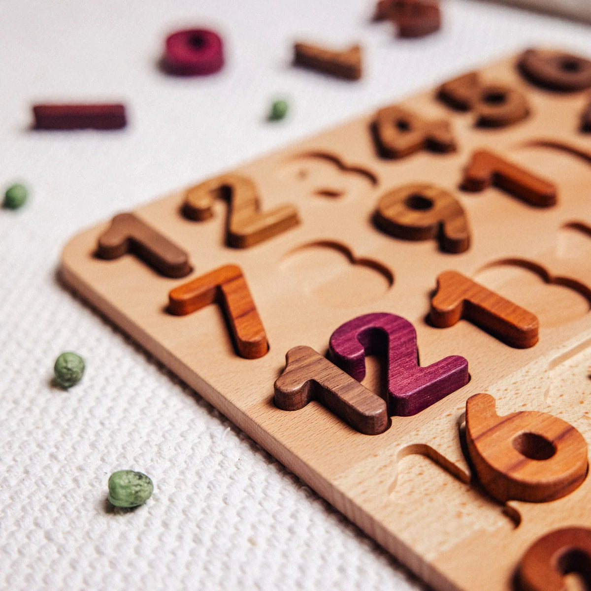 Extended Wooden Number Puzzle partially assembled, showing Mahogany, Tigerwood, Walnut and Purpleheart digit pieces in inset