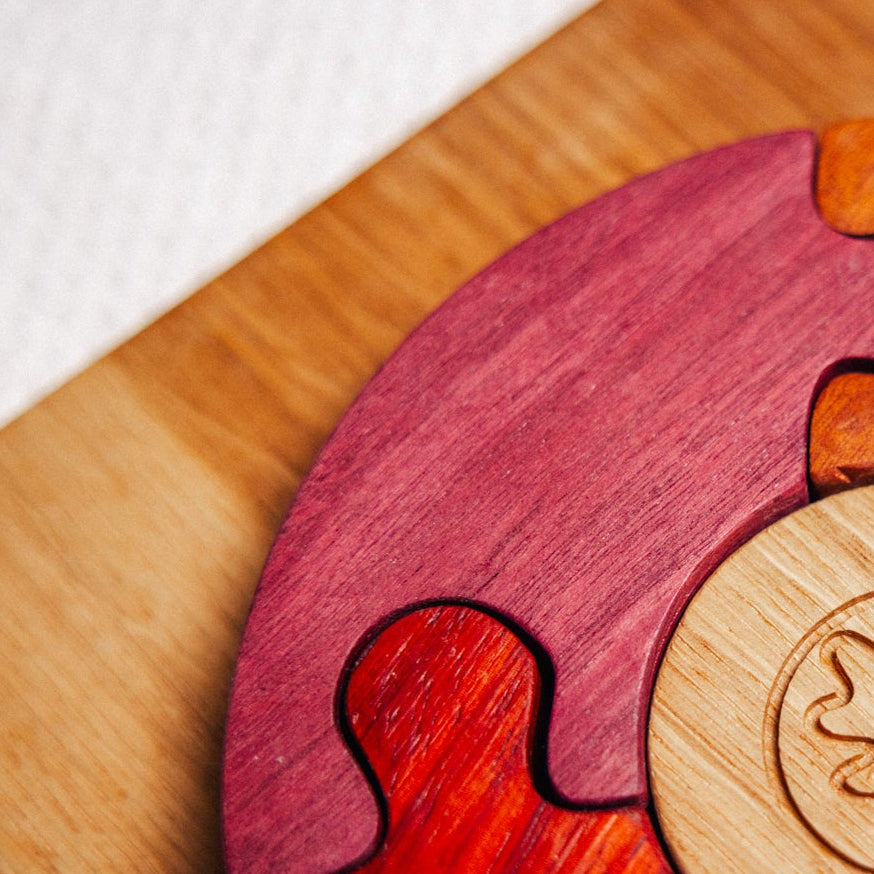 Wooden puzzle piece with a unique design on a wooden surface