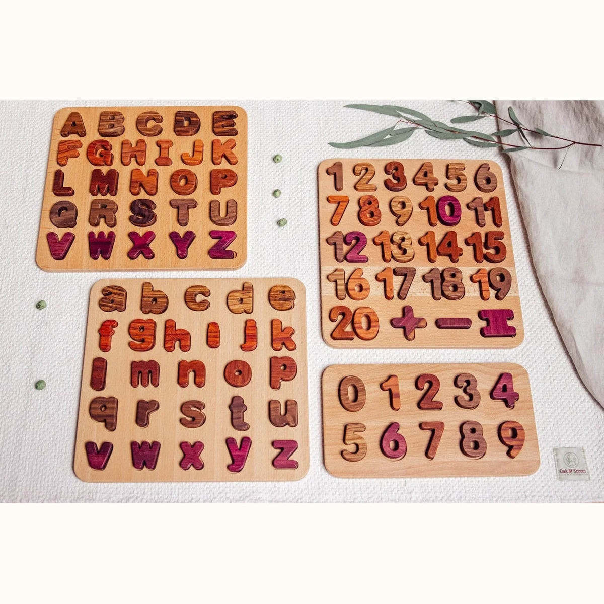 Oak & Sprout 0–9 Numbers Puzzle assembled in flat-lay with Purpleheart, Tigerwood and Walnut pieces on white linen