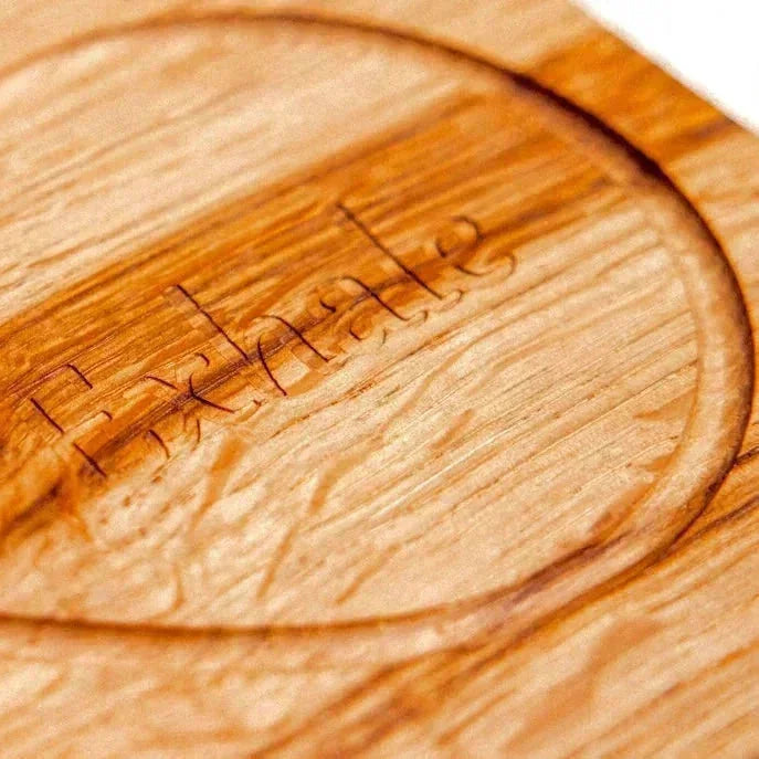 Oak & Sprout free learning resources wooden board back showing engraved maker's mark in routed recess, warm amber hardwood